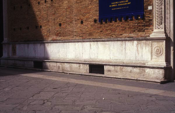 Bench along palace façade, originally fitted with carvings of drawings by Francesco di Giorgio.