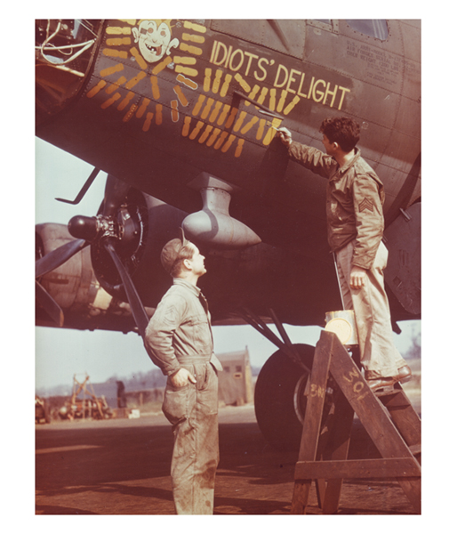 A crewman adds another mission marker to the combat tally on the fuselage of the B-17 Idiots' Delight.
